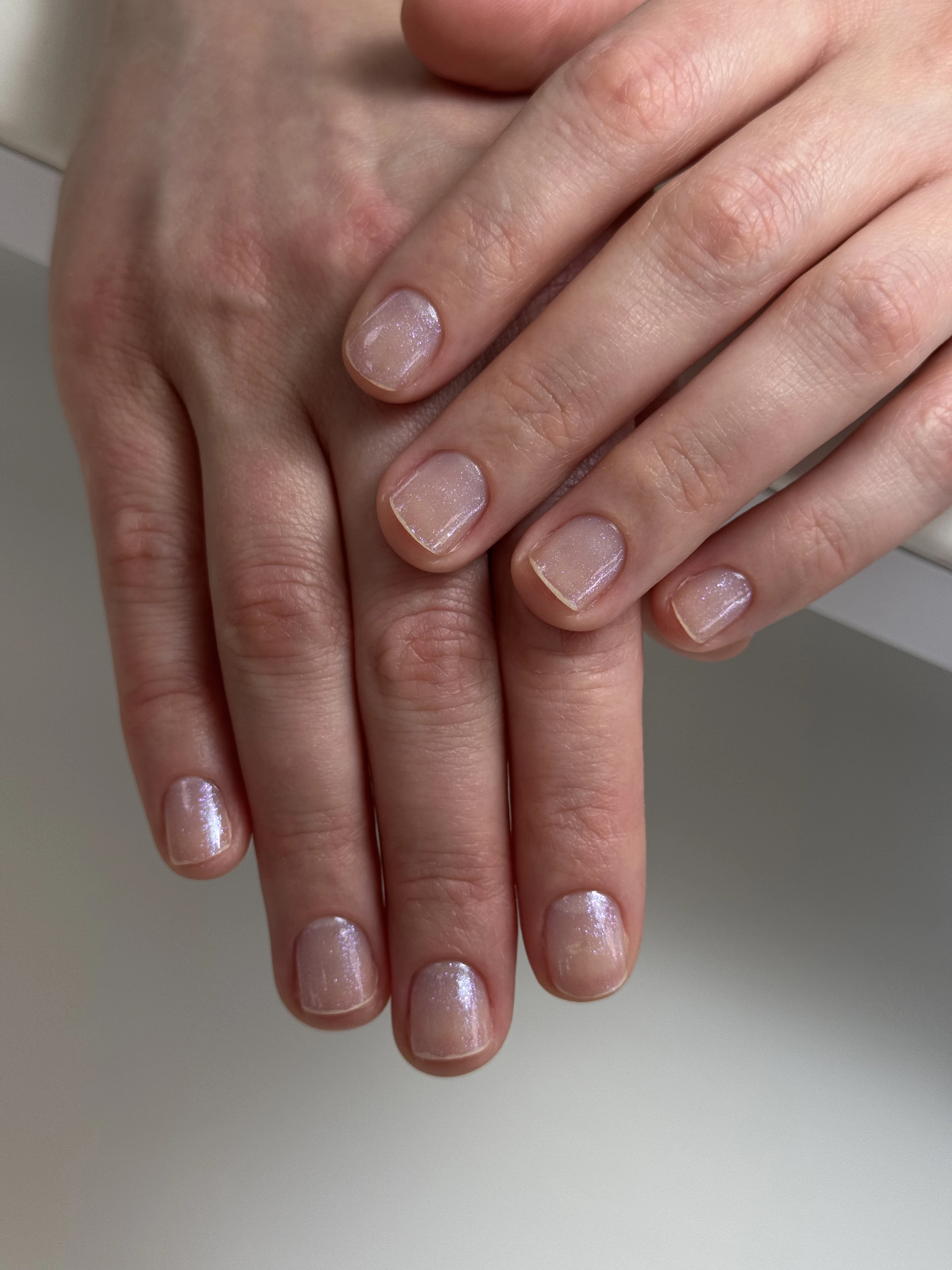 Iridescent sheer pink regular polish on squoval nails layered softly, applied at My Beauty Space nail studio in Mississauga.