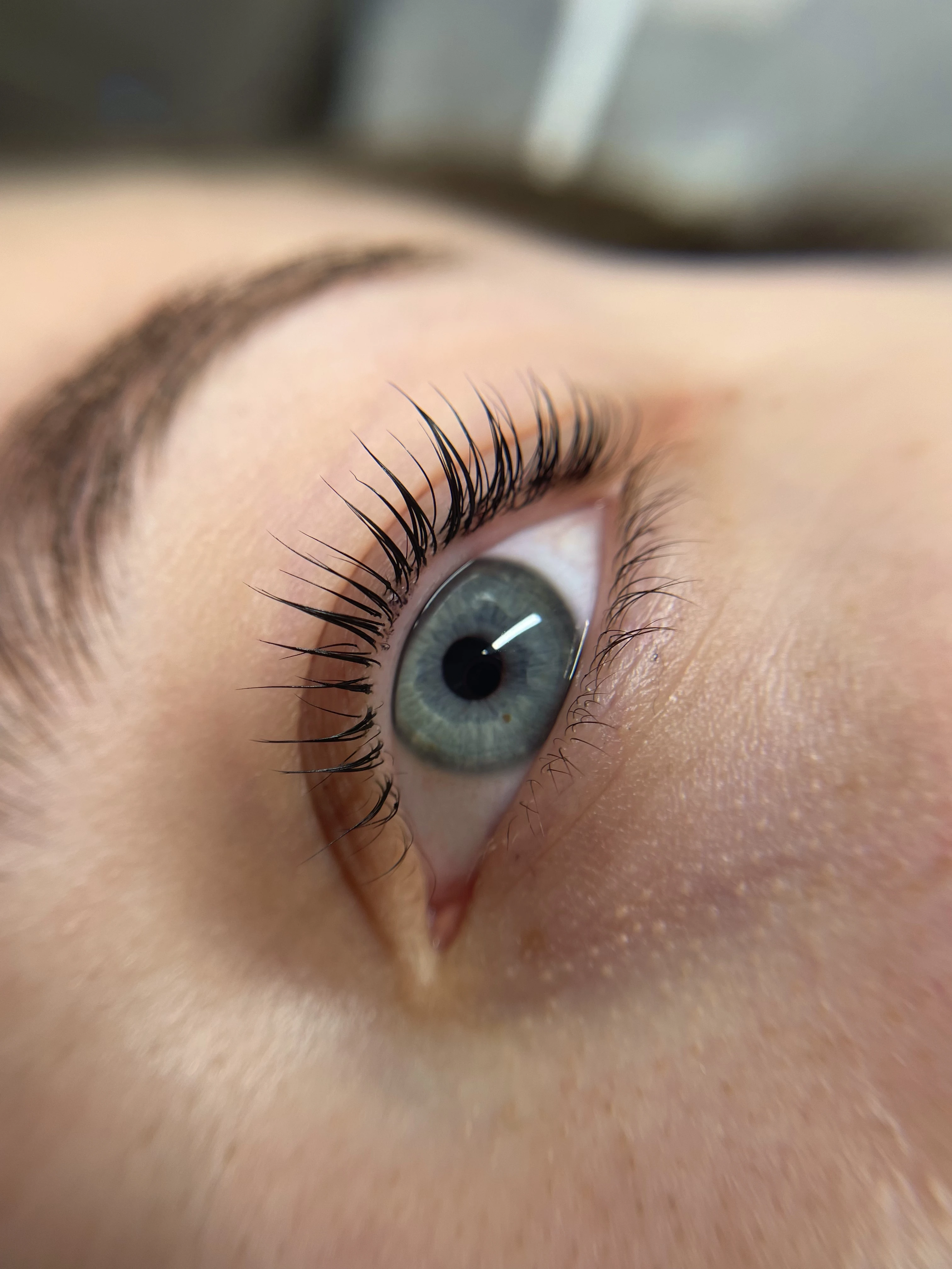 High-angle lash lift and tint with glossy black curl on blue-grey eyes at My Beauty Space Mississauga.