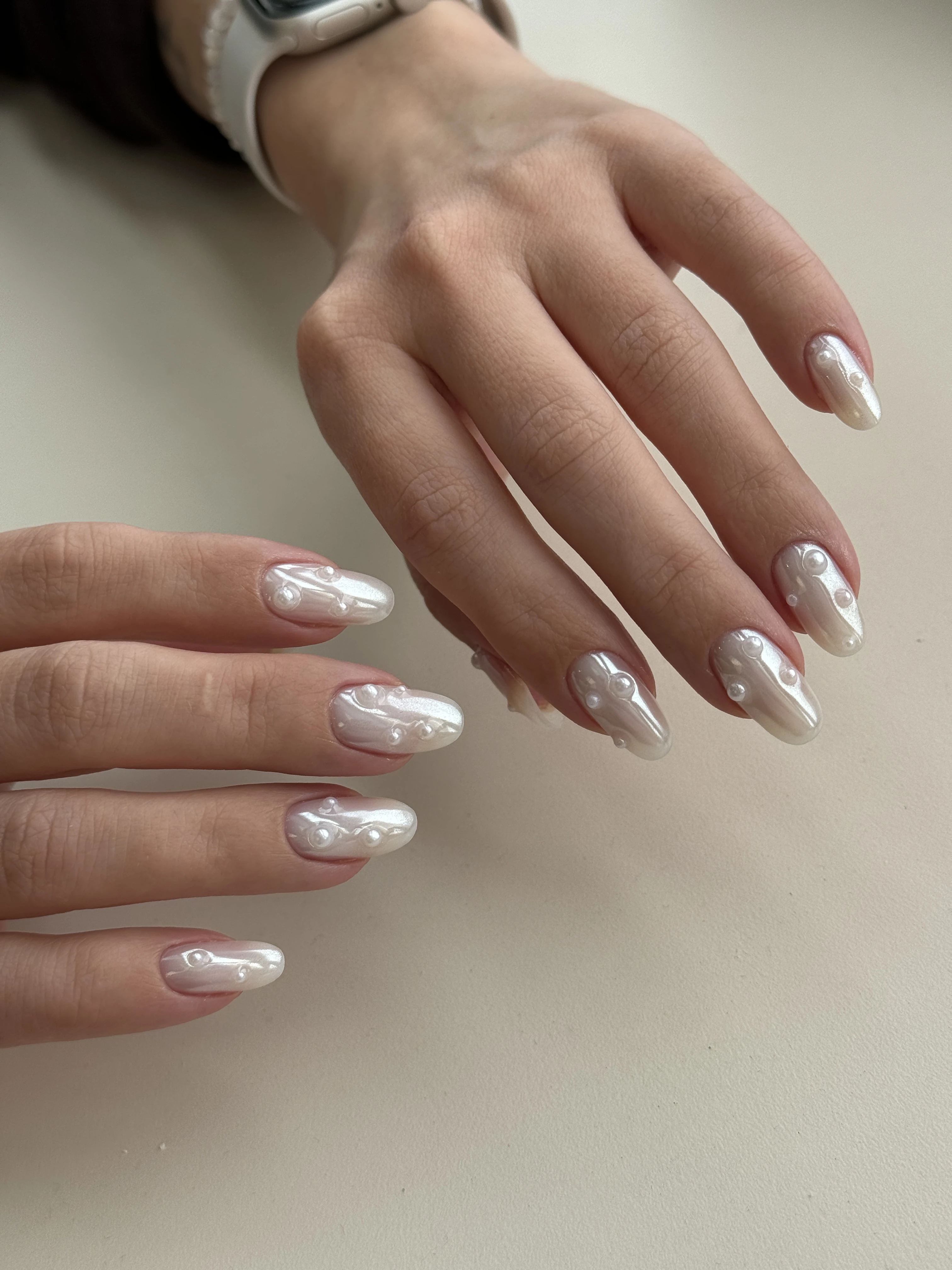 Hard gel almond nails at My Beauty Space with iridescent white chrome and scattered 3D pearl embellishments.