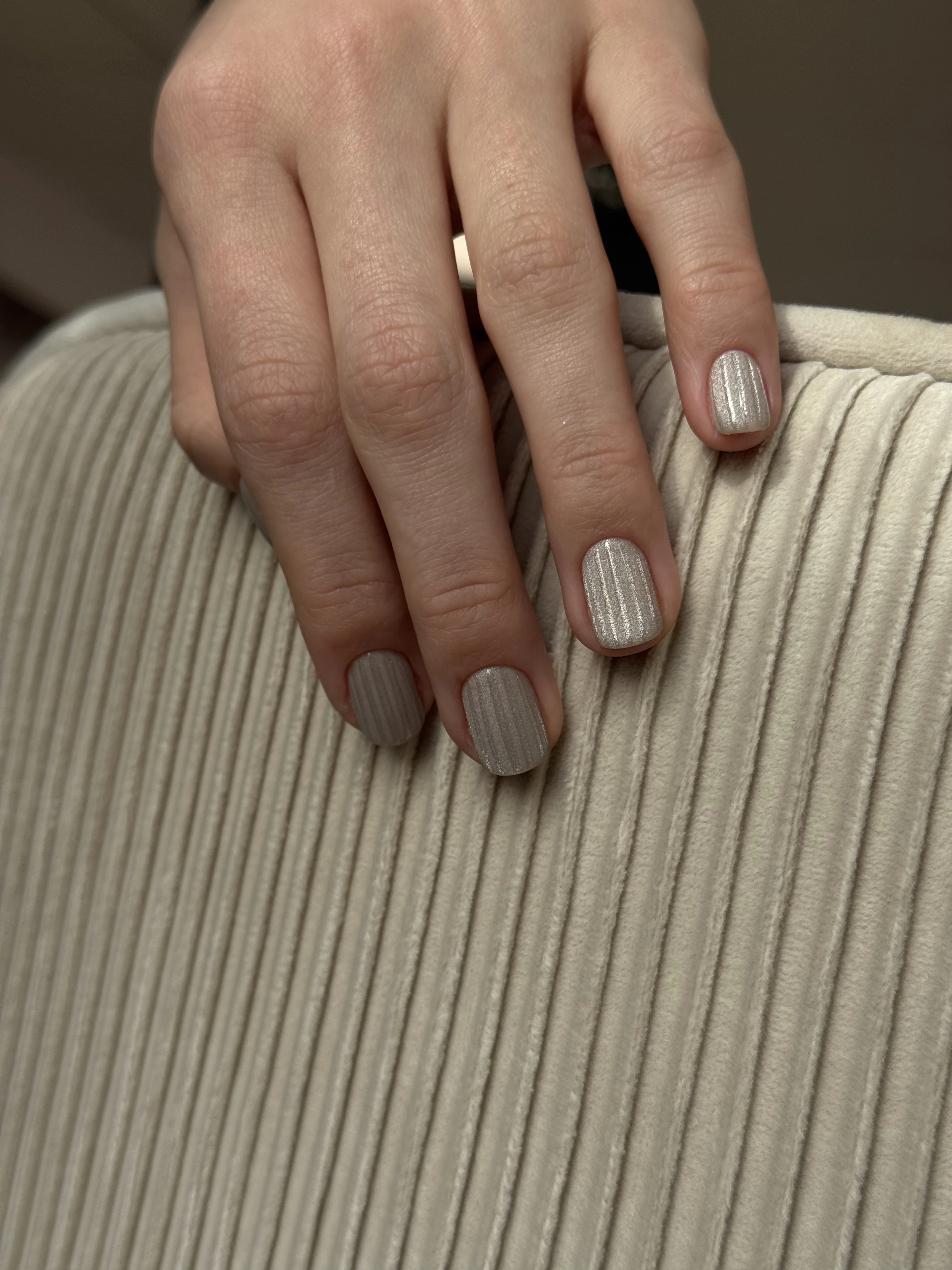 Champagne cat-eye nail art at My Beauty Space Mississauga on short squoval nails over beige ribbed fabric.