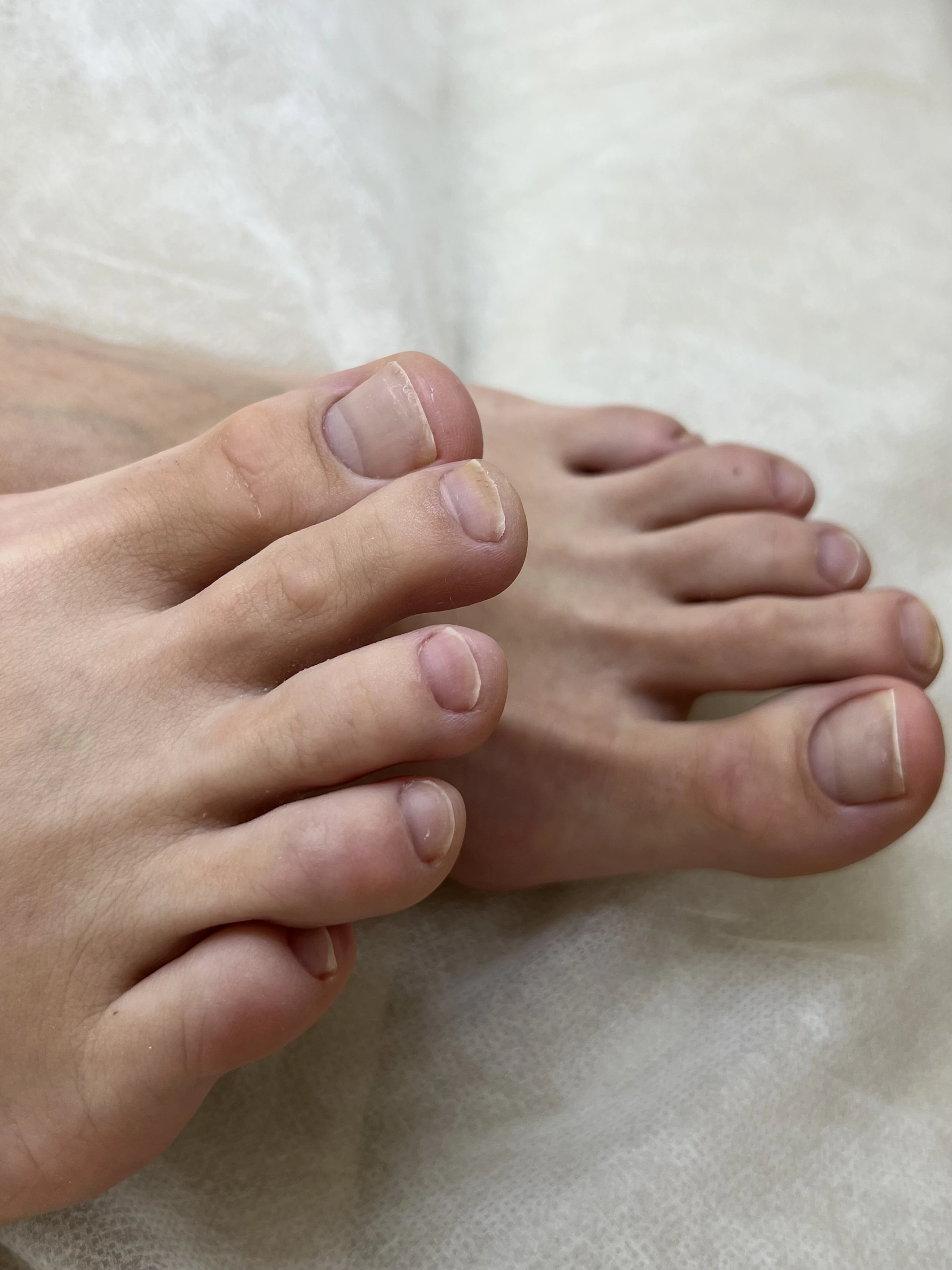 Natural no-polish pedicure at My Beauty Space Mississauga: short buffed toenails with clean cuticles on white paper.