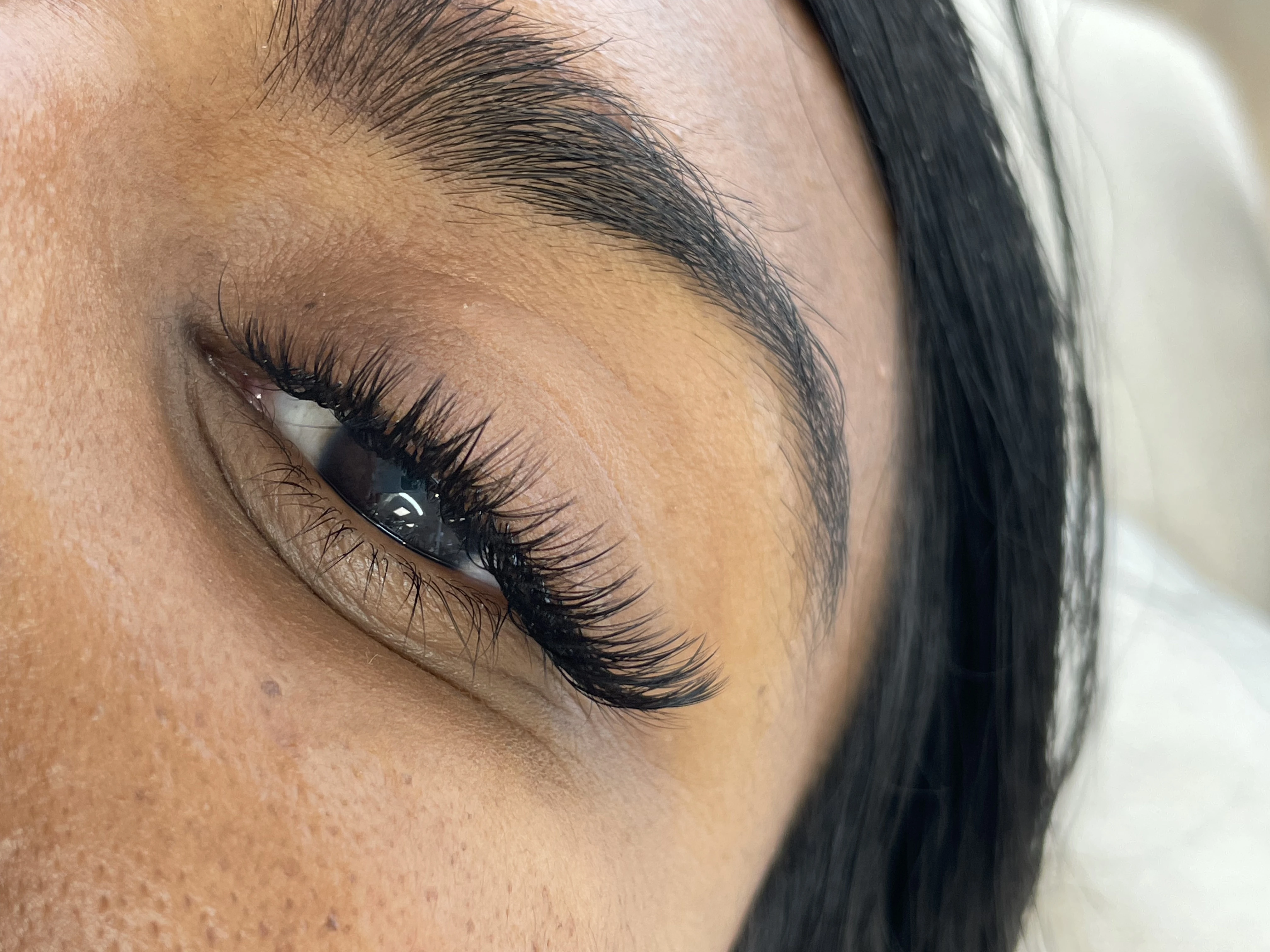 Medium-tan skin with light hybrid 2D lash fans and a sharp arched brow at My Beauty Space Mississauga.